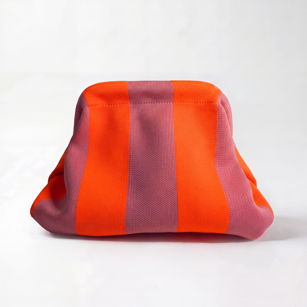Striped orange and pink fabric clutch bag with rounded top and stitched edges