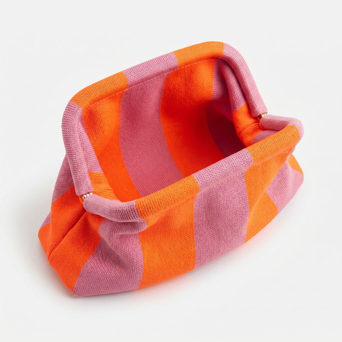 Striped orange and pink fabric clutch bag with top opening and handle loop