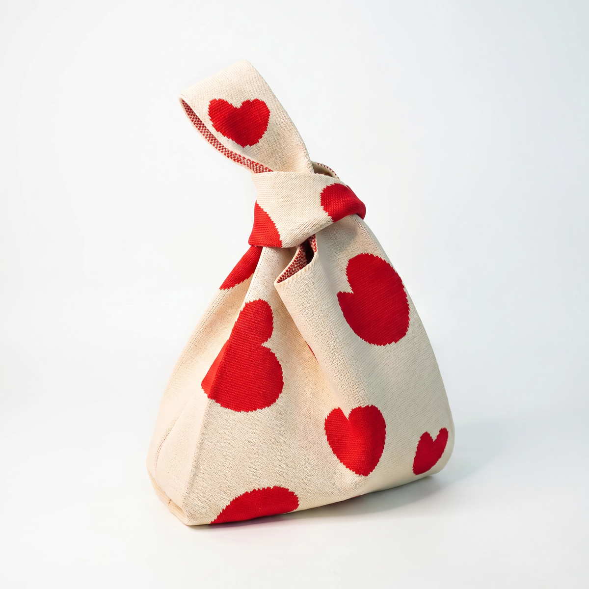 Cream heart-print drawstring handbag with twisted top handle
