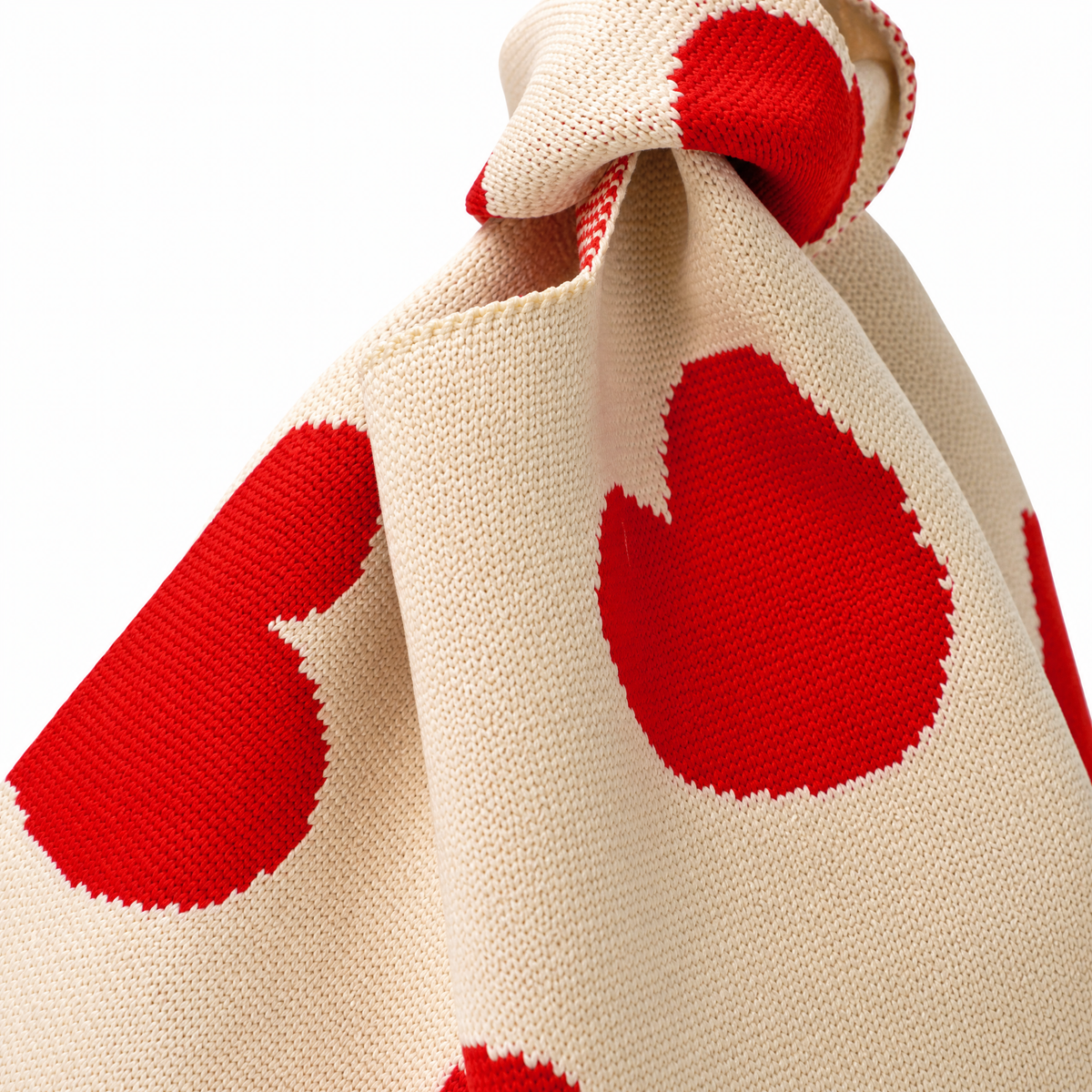 Cream canvas heart-print drawstring handbag, knotted strap and close-up top