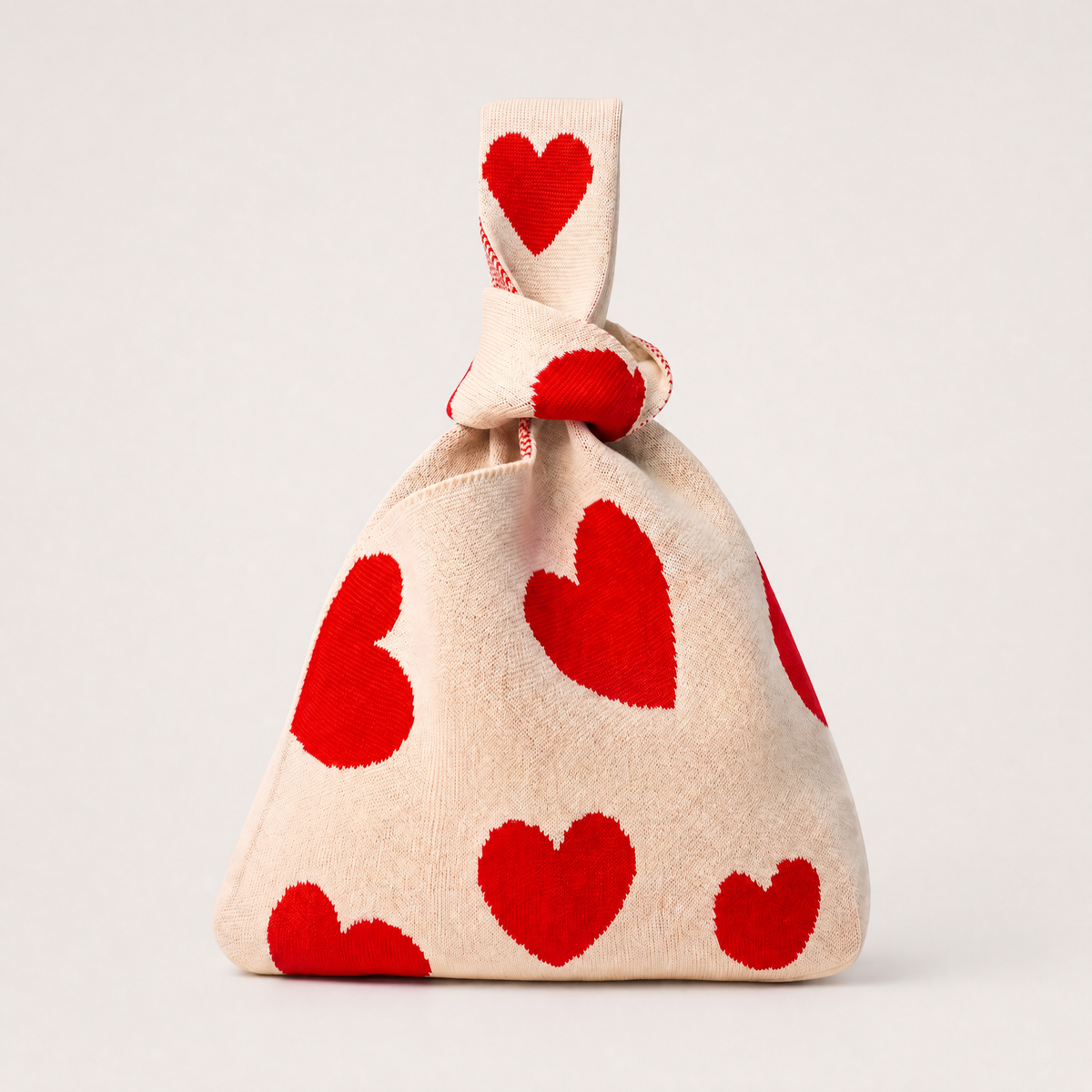 Cream canvas heart-print drawstring handbag with gathered top and knotted handle