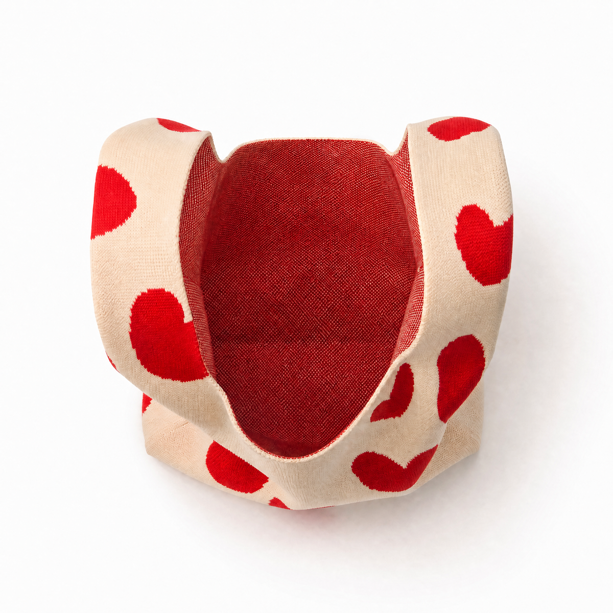 Cream heart-print mini handbag with open top showing red-lined interior