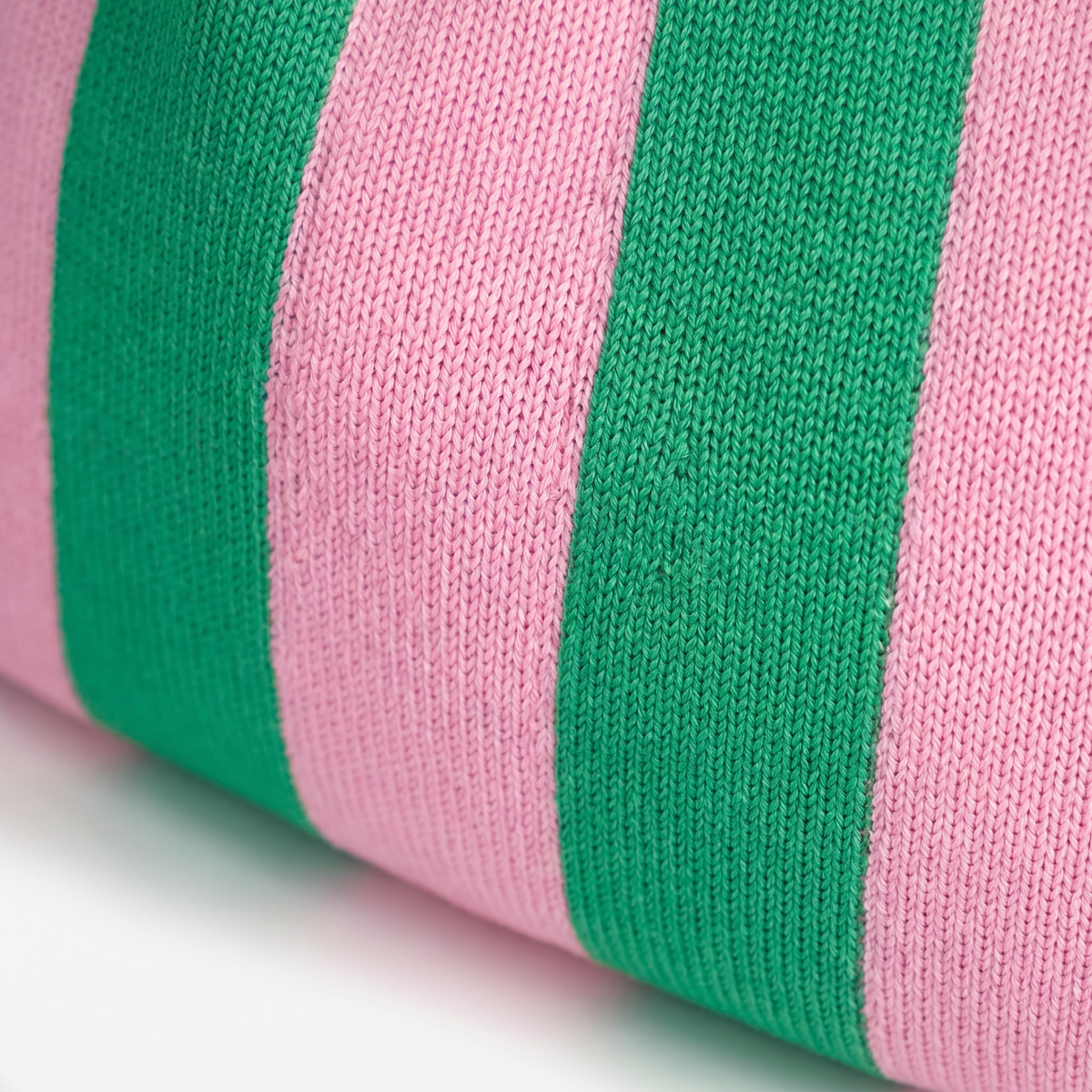 Close-up of green and pink striped knit fabric on the handbag body