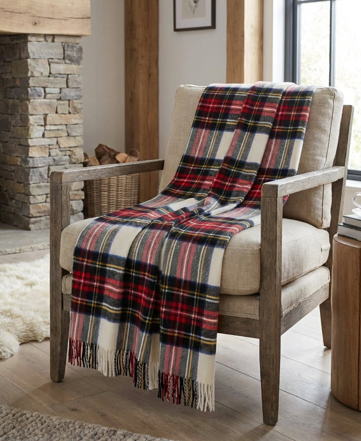 Plaid throw blanket over armchair in red, navy, blue, yellow, and cream tartan checks