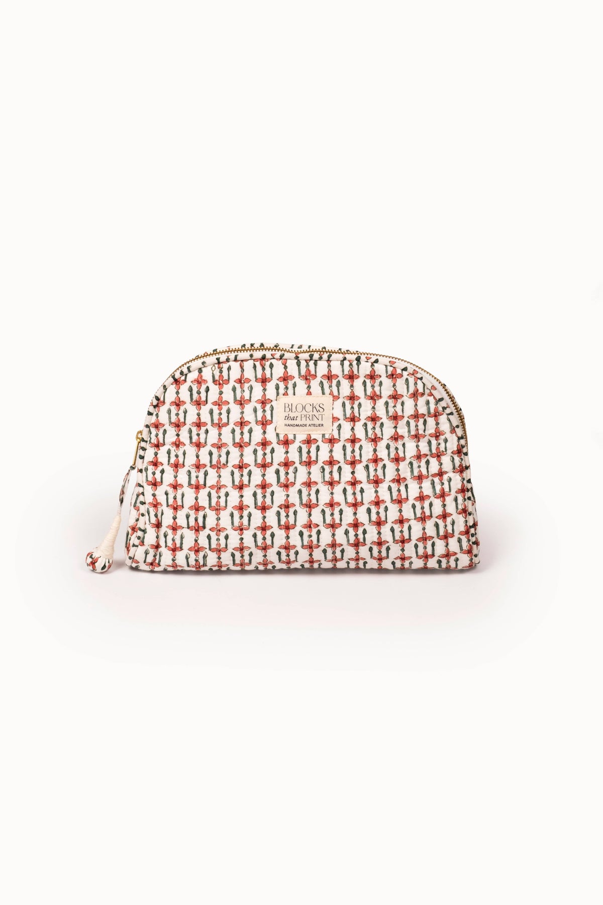 Quilted travel pouch, crimson block-print pattern, rounded top, zip pull.