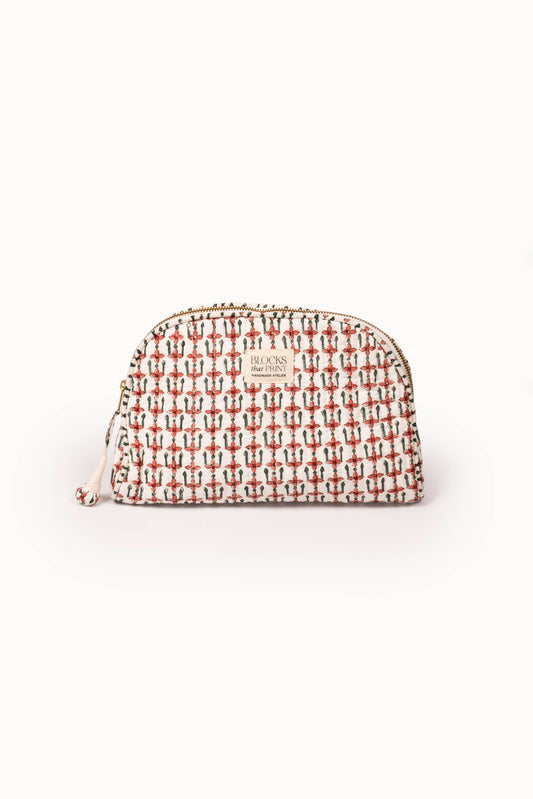 Quilted travel pouch, crimson block-print pattern, rounded top, zip pull.