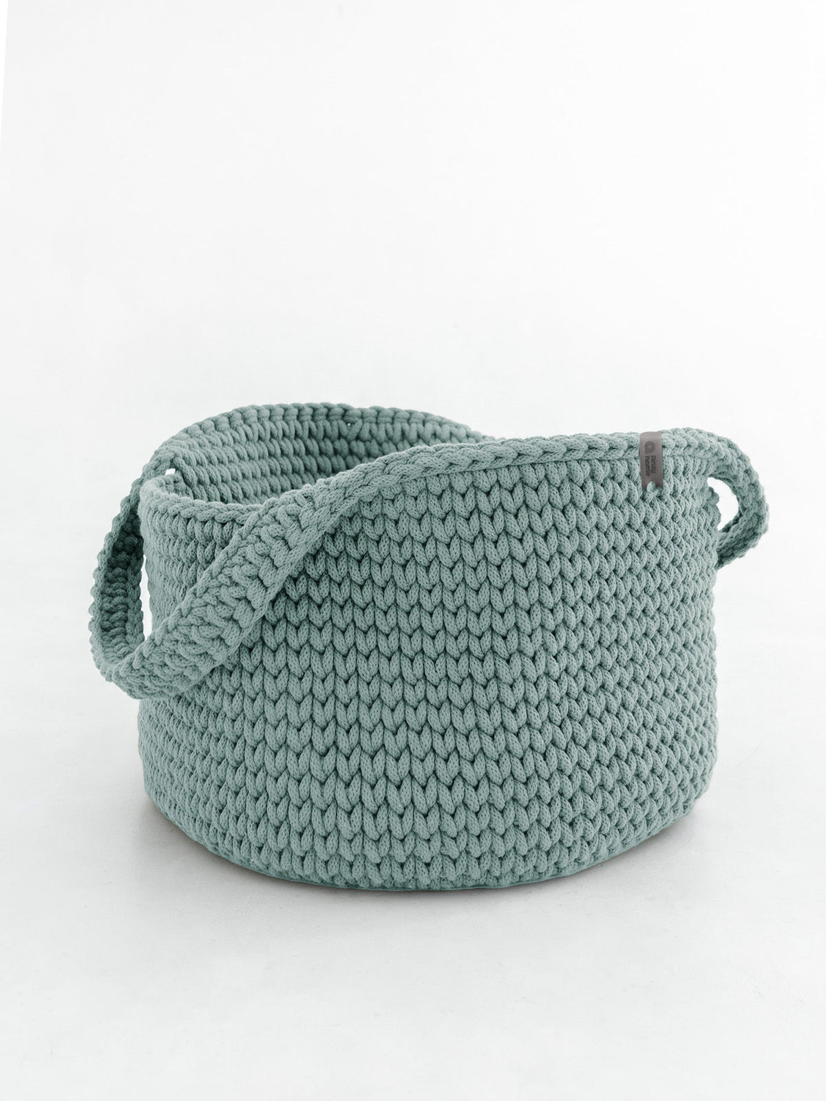 Round knitted storage basket with handles in teal green, thick knit weave