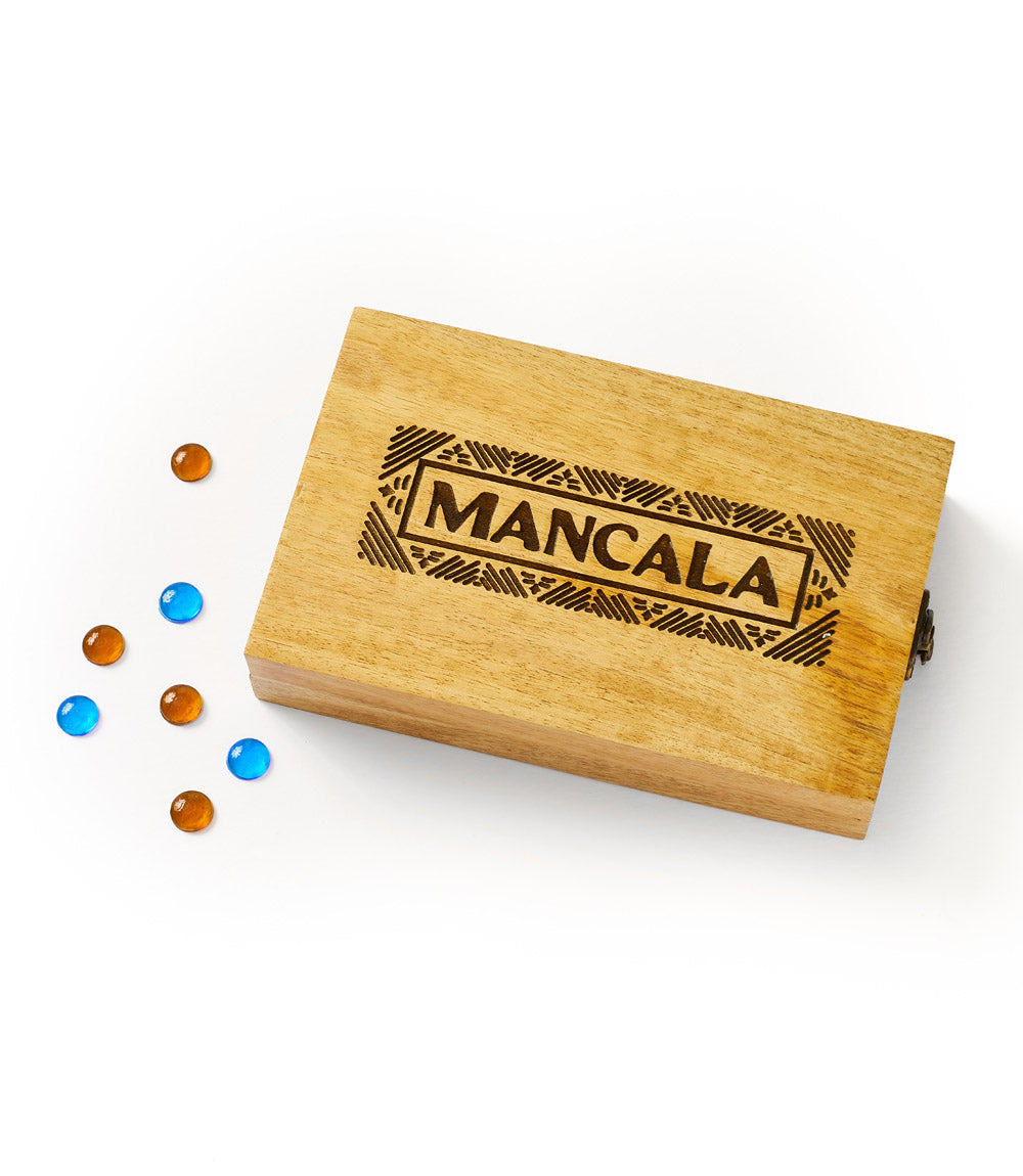 Mancala wooden game board with carved MANCALA logo and a few blue and amber beads