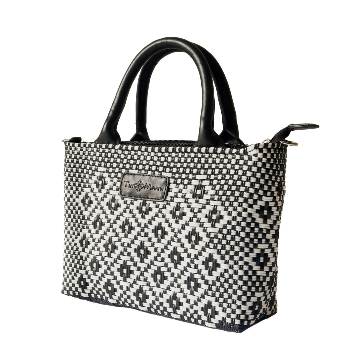 Small woven crossbody bag, black-and-white weave with black leather handles and side ties.