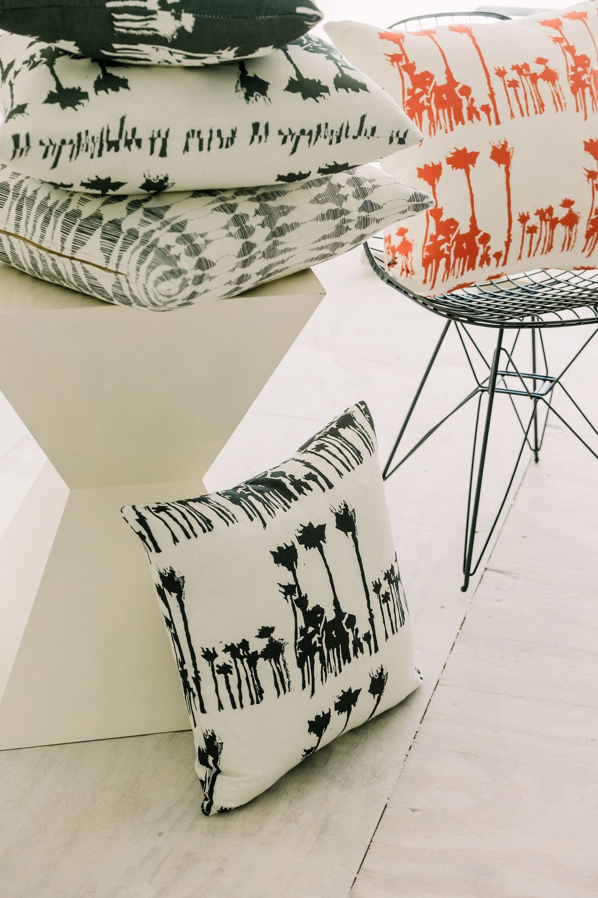 Bosque throw pillow set with black animal silhouettes on white fabric