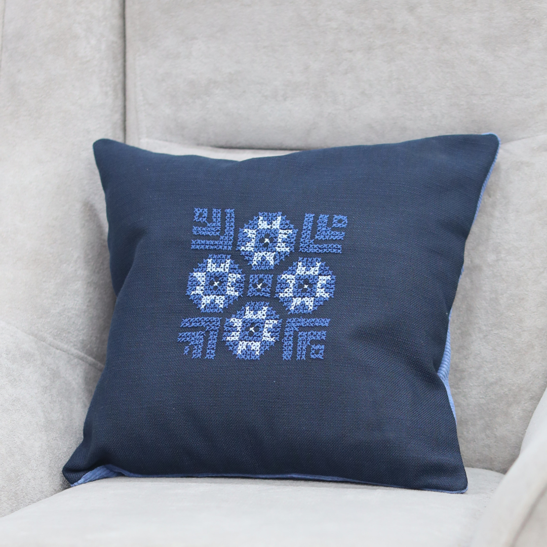 Blue pillow cover with cross-stitch geometric and snowflake pattern embroidery