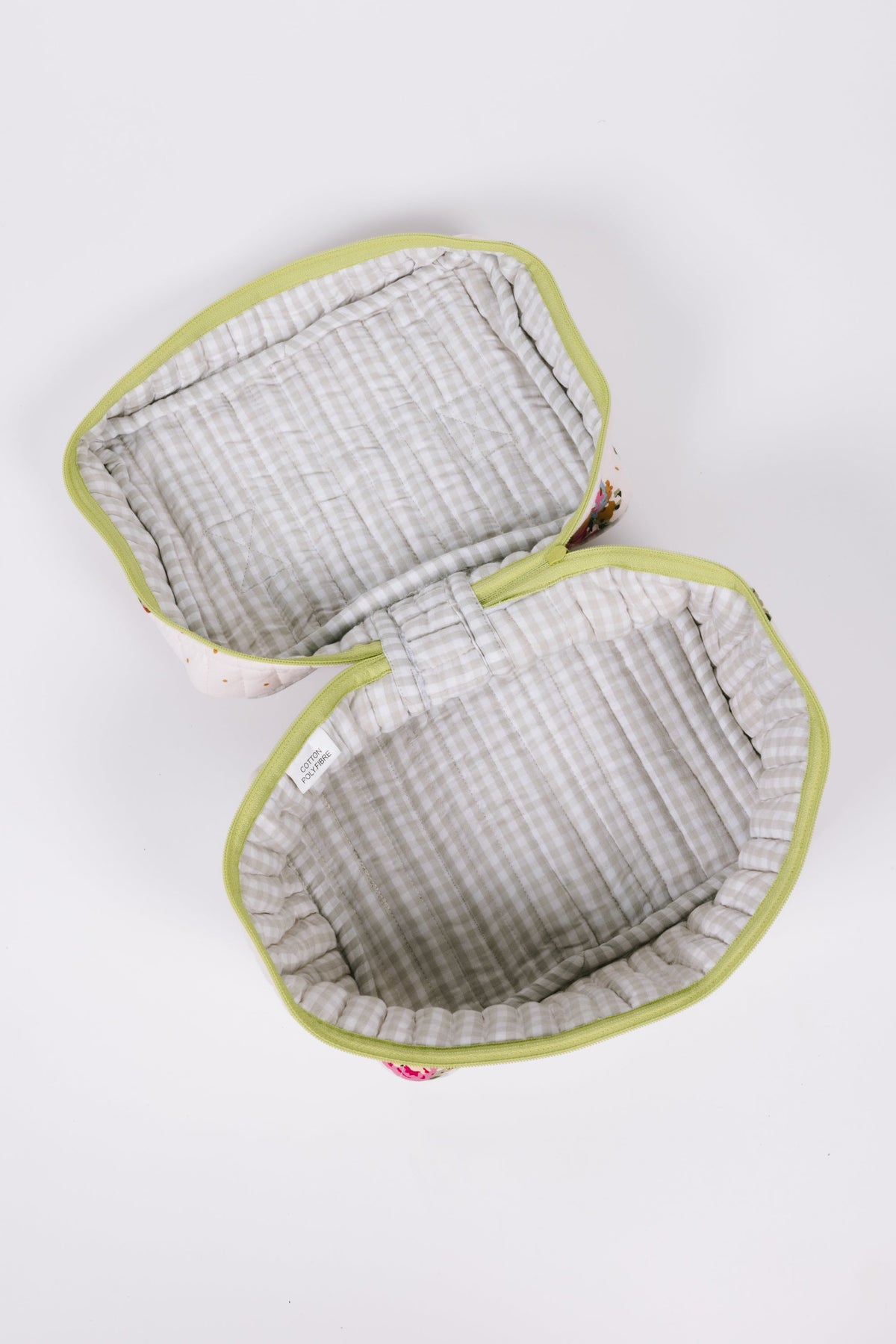 Travel case with two-fold openings showing gray plaid quilted lining and lime edges