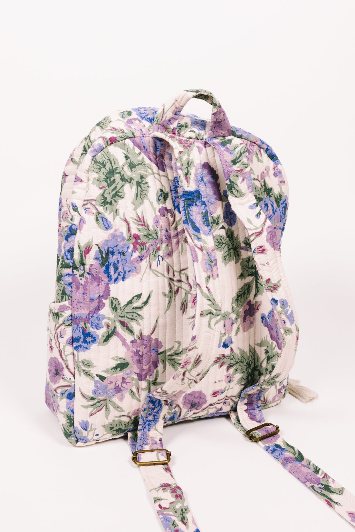 Quilted floral backpack with side drawstring and long shoulder strap, cream backing