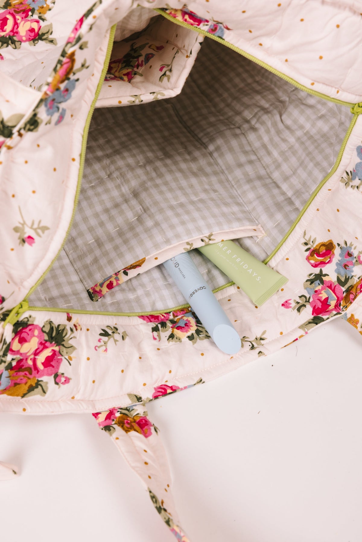 Floral zip tote bag with green plaid lining and open interior pocket
