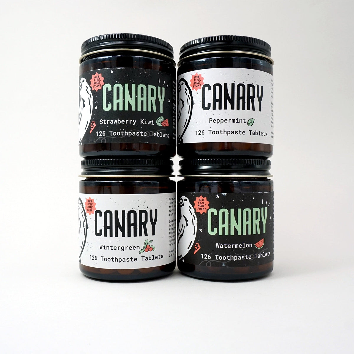 Canary toothpaste tablet sampler in four jars labeled strawberry kiwi, peppermint, wintergreen, and watermelon