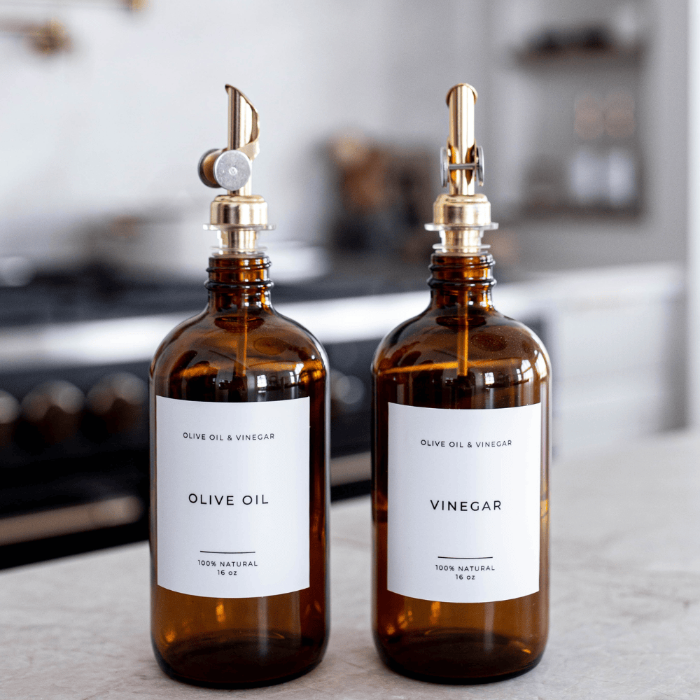 Amber glass olive oil and vinegar dispenser bottles with pour spouts and white labels
