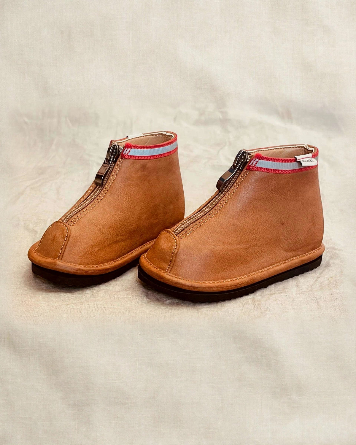 Toddler brown ankle boots with side zipper and red trim, pair view