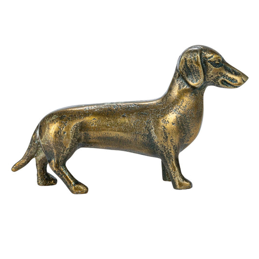Antique brass dachshund figurine in cast aluminum, side profile, long body.