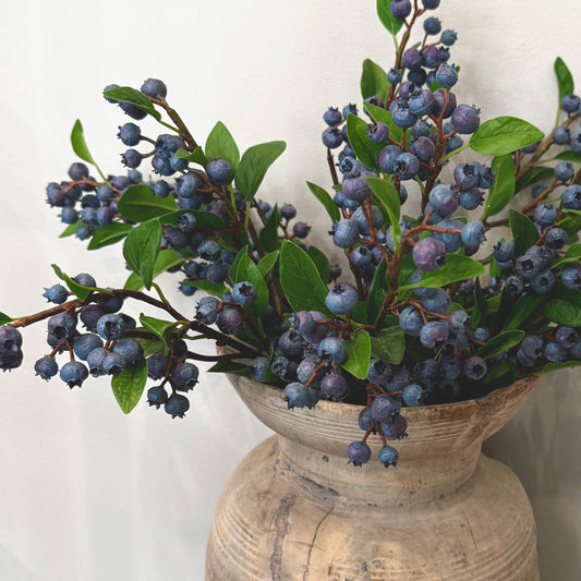 Faux blueberry pick with dark blue berries and green leaves on long stem
