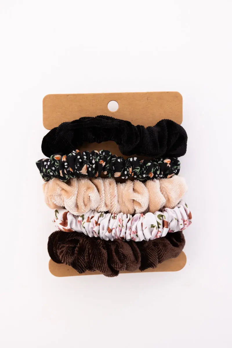 Assorted autumn floral hair scrunchies on card: black, beige, floral, and dark brown