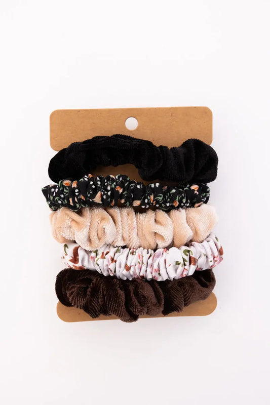 Assorted autumn floral hair scrunchies on card: black, beige, floral, and dark brown