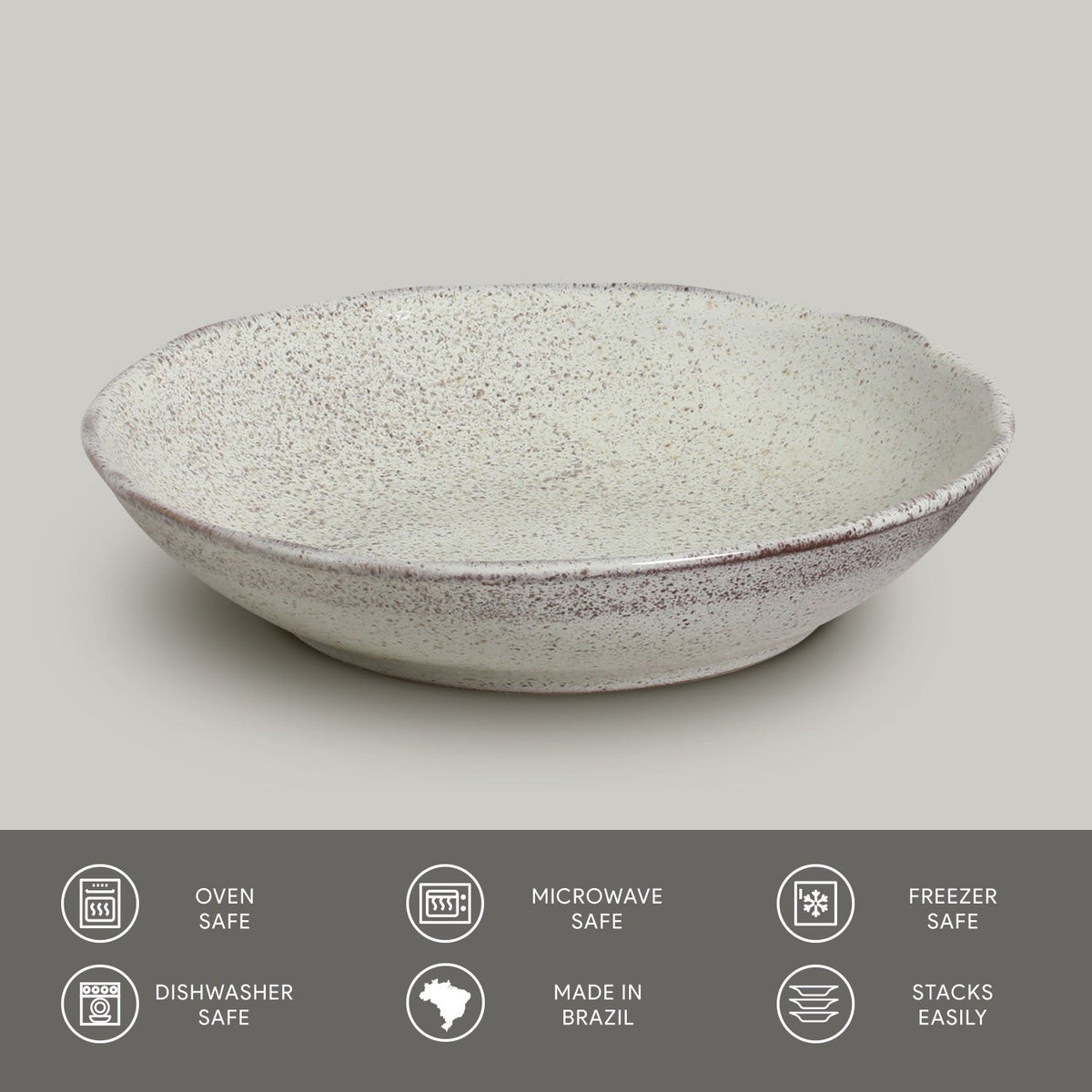 Light speckled reactive glaze pasta plate, round shallow bowl with curved rim.