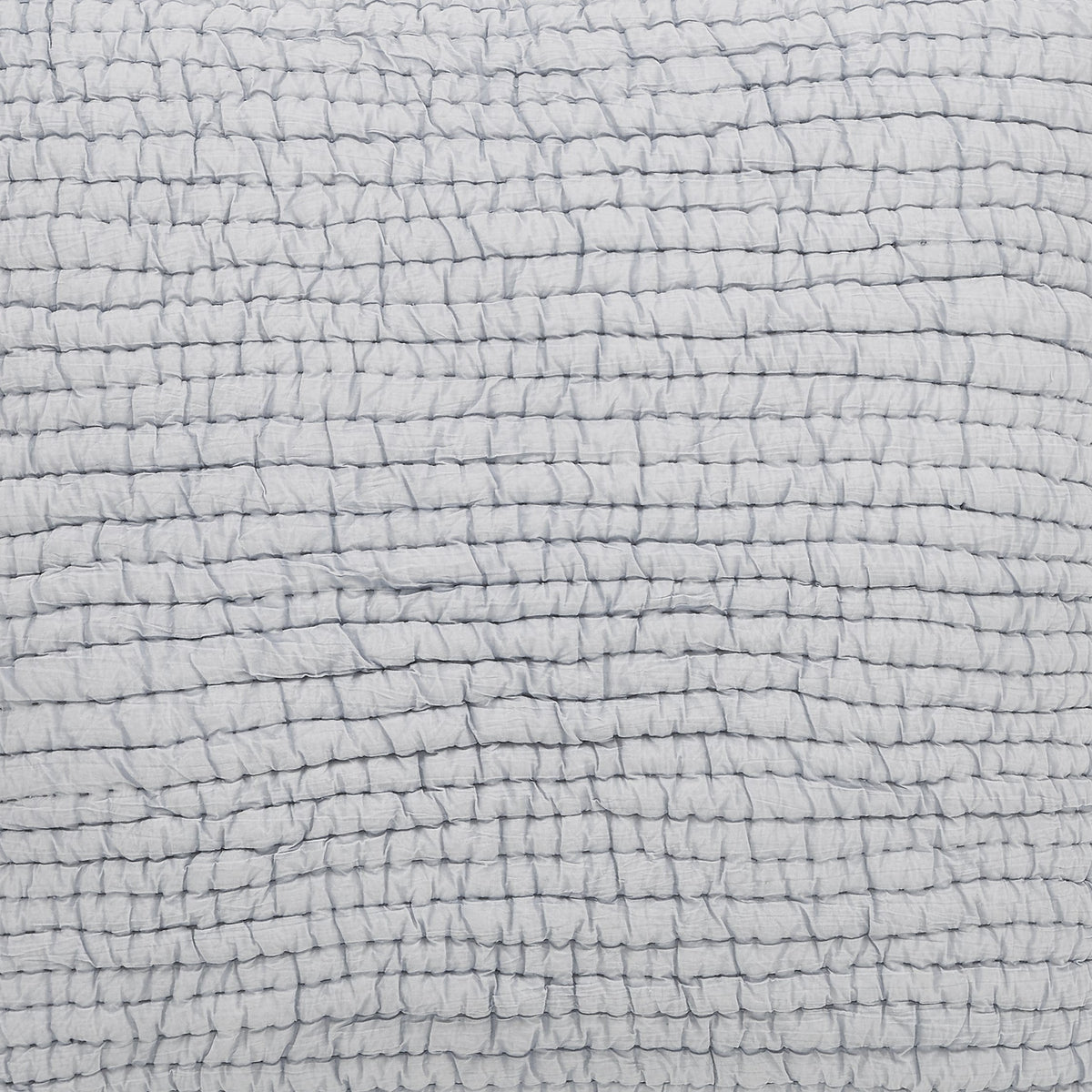 Stone-washed cotton quilt fabric close-up in light gray with woven grid texture.