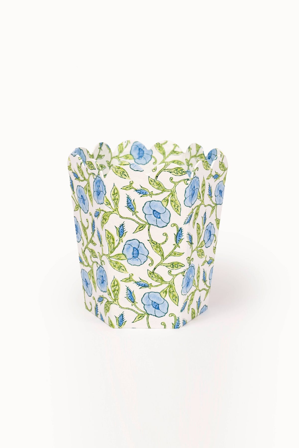 Collapsible fabric storage basket with blue flowers and green vines block print.