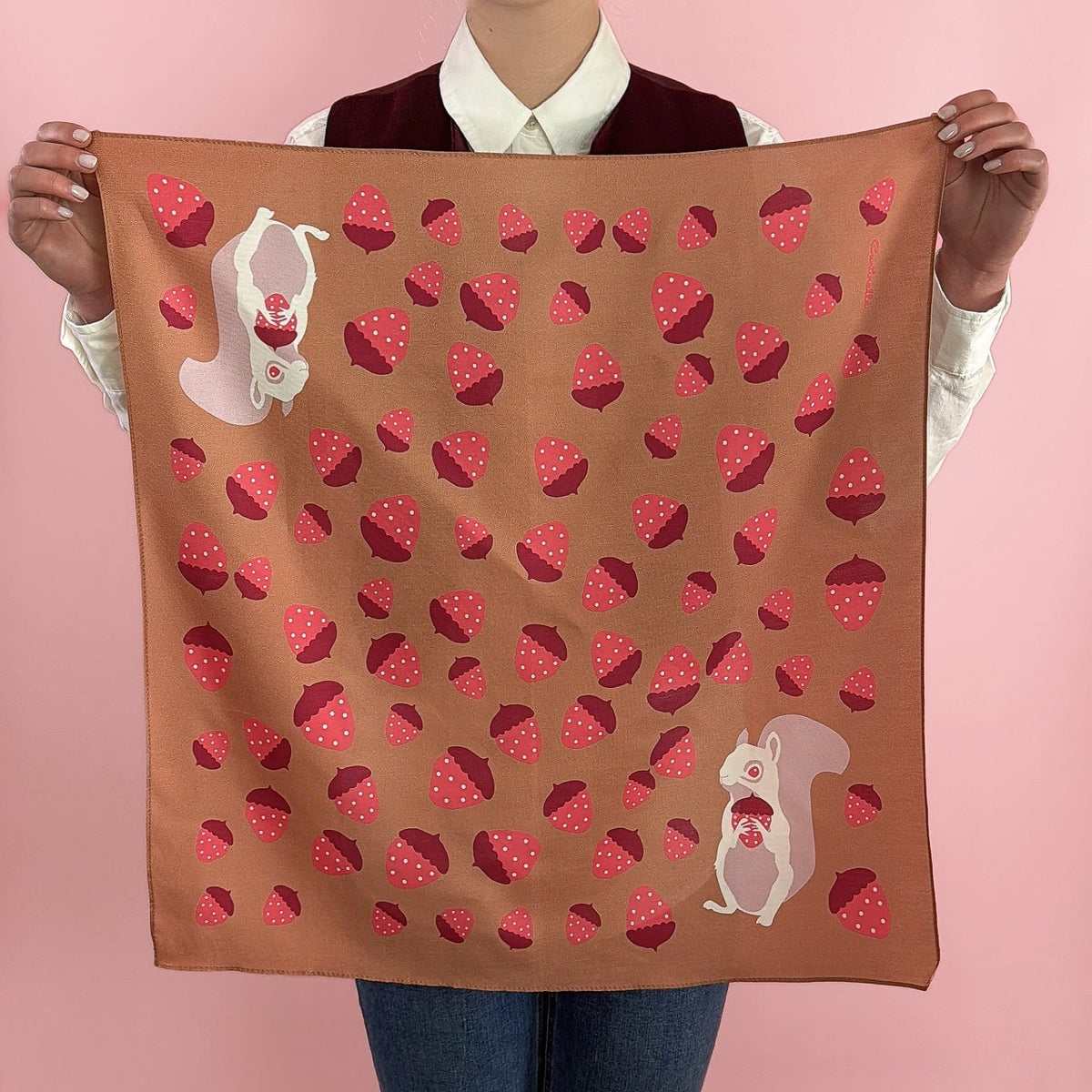 Cotton-silk bandana held up: tan fabric with red strawberry print and rabbit motifs.