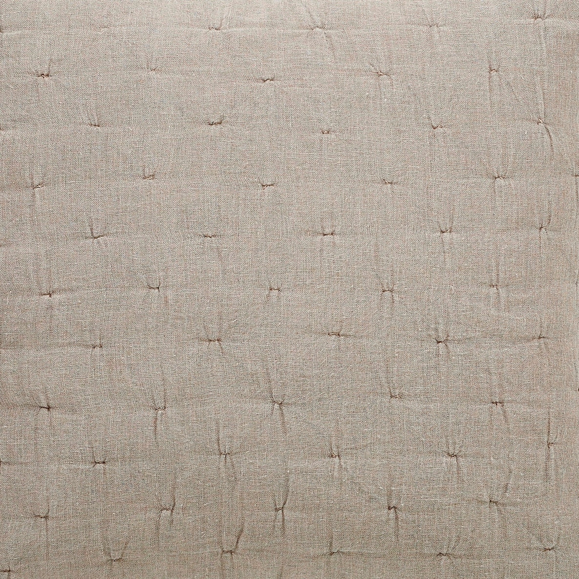 Light beige linen quilt fabric close-up of pinched stitching and woven texture.