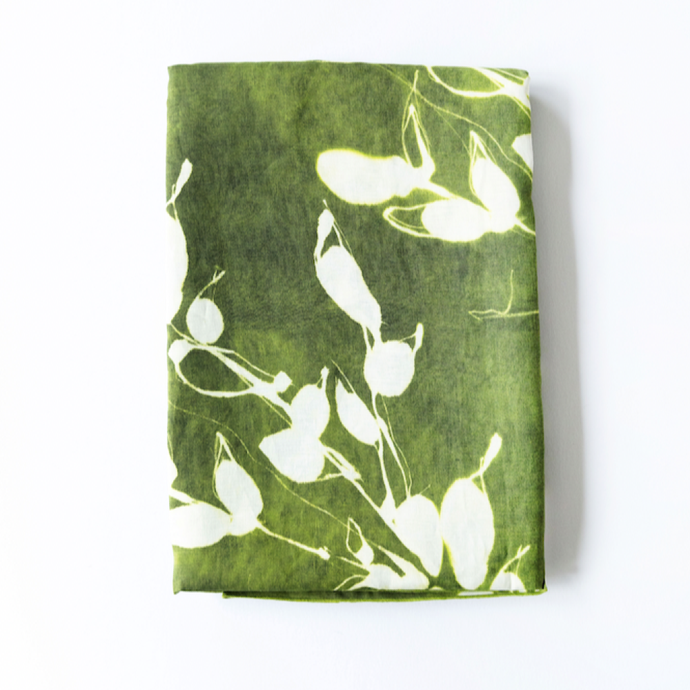 Olive green tablecloth with white leaf print, flat view