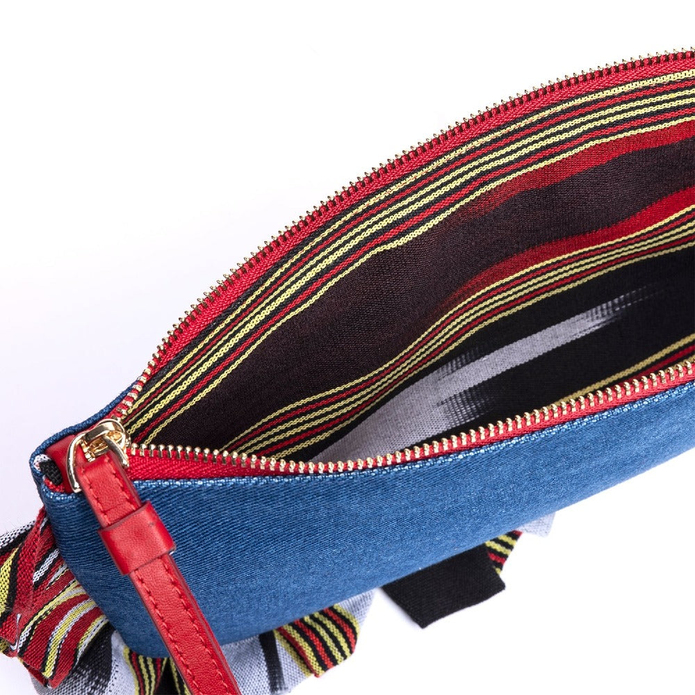 Blue denim clutch bag with red zipper and leather pull; striped trim edge detail