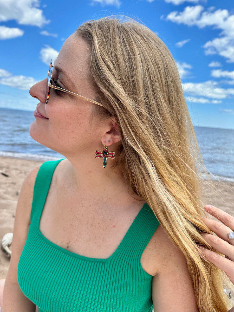 Beaded dragonfly earrings with red and teal wings on gold hooks