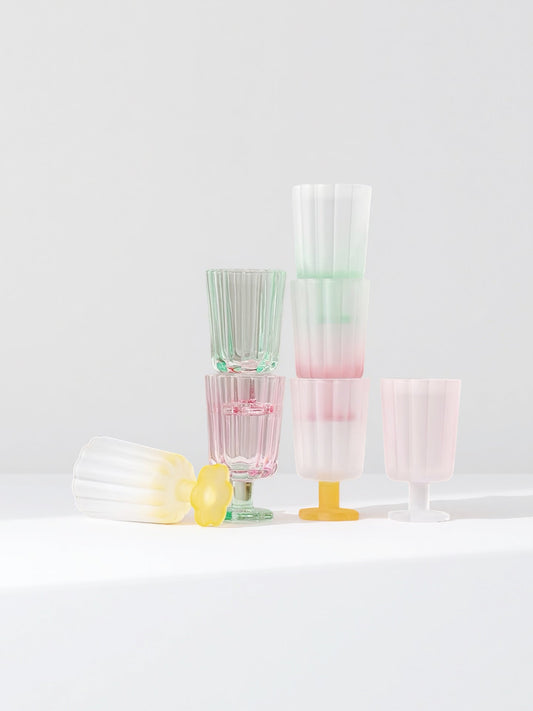 Set of hand-blown petal goblets in pastel pink, green, yellow, and white.