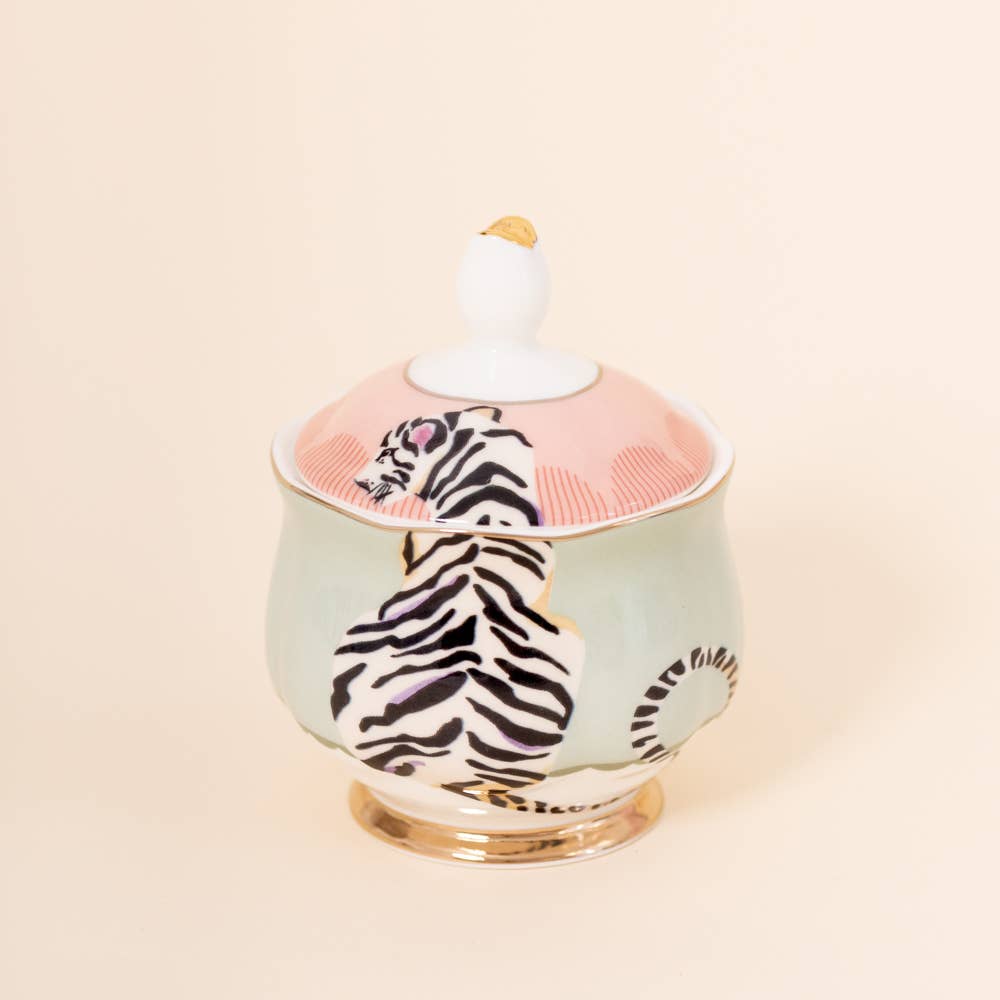 Tiger-print sugar bowl with white knob lid on a mint-green ceramic base