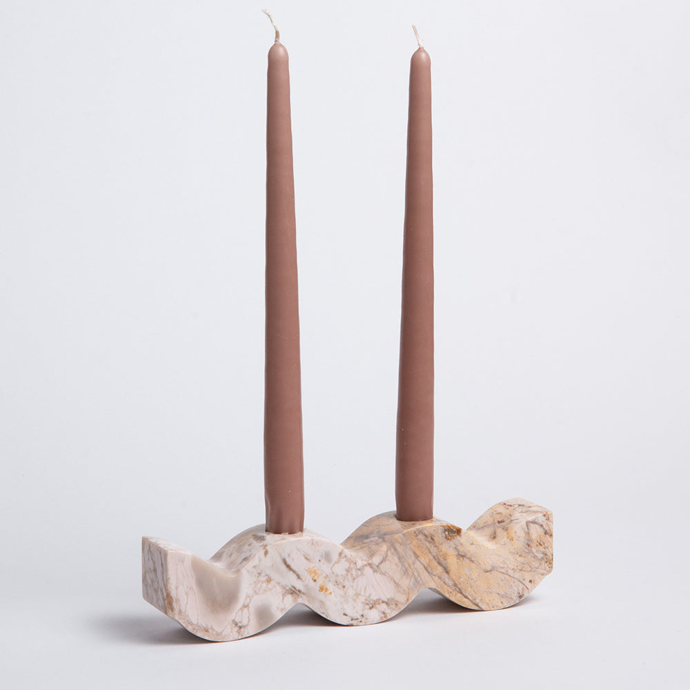 Wavy soapstone candelabra with two cream candles and a carved veined base