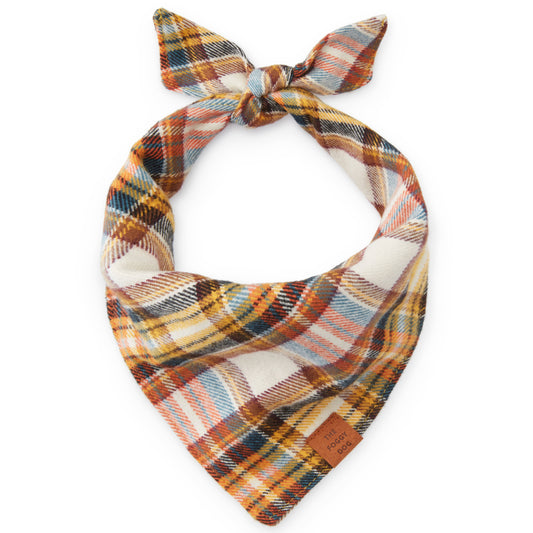 Flannel dog bandana with orange, blue and white plaid, triangular style with tied bow