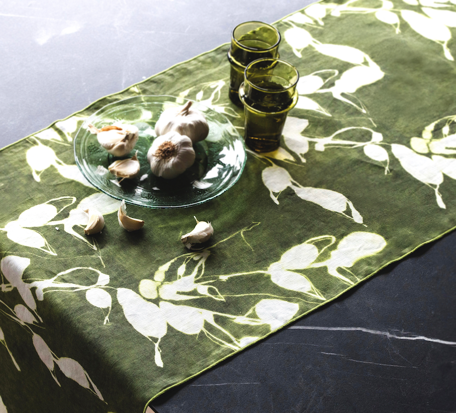 Olive green floral table runner with white botanical print, diagonal angle