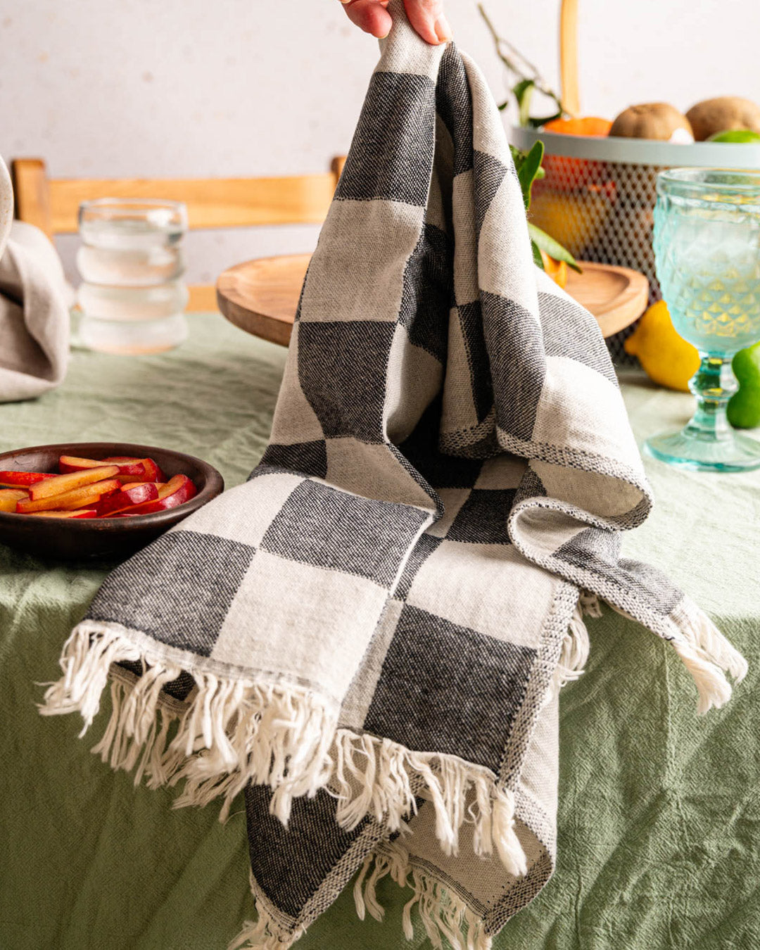 Folded kitchen towel with gray-and-beige check pattern and fringed ends