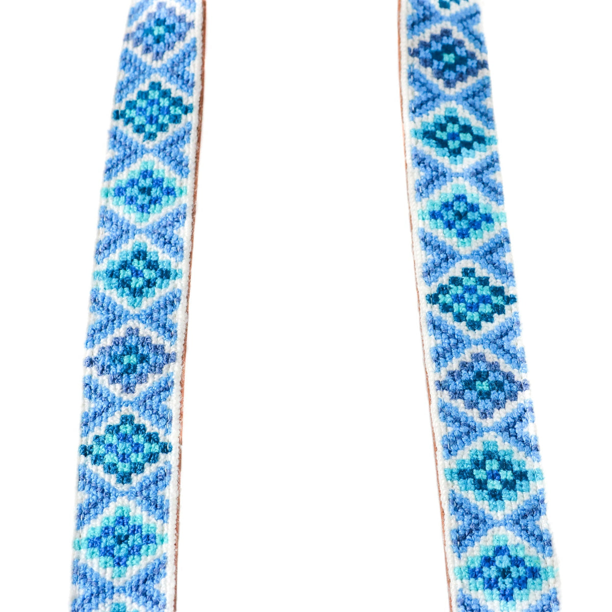 Woven blue strap with geometric diamond pattern, stitched edges and tan borders