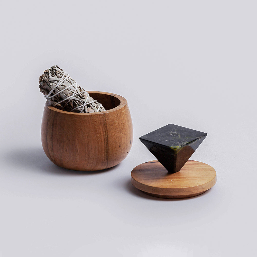 Round wooden jewel box with sage bundle inside; black triangular lid