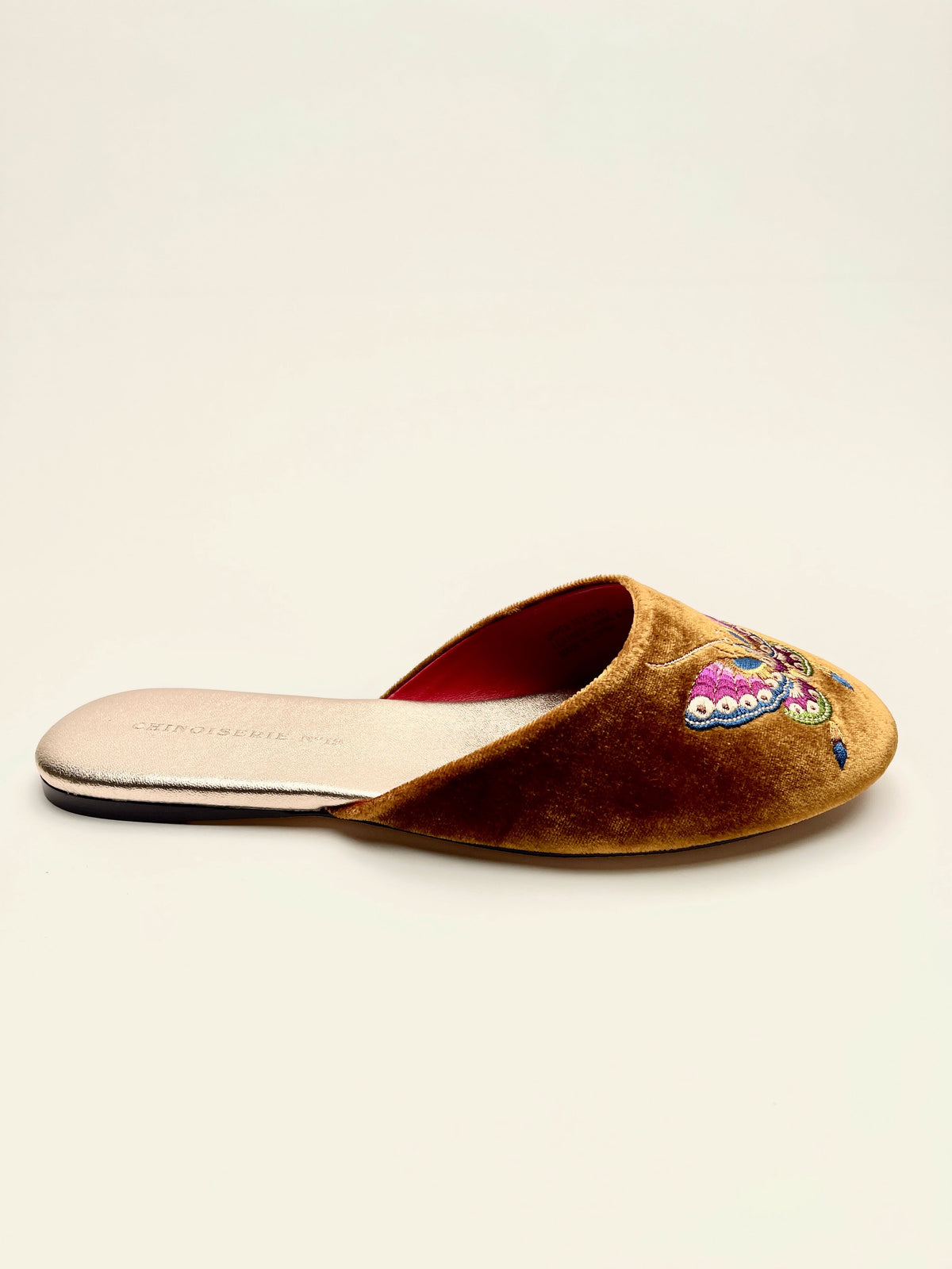 Antique gold velvet mules with butterfly embroidery and red-lined opening