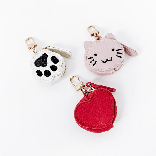 Set of three pet bag charms: paw print, pink cat, and red heart with clips