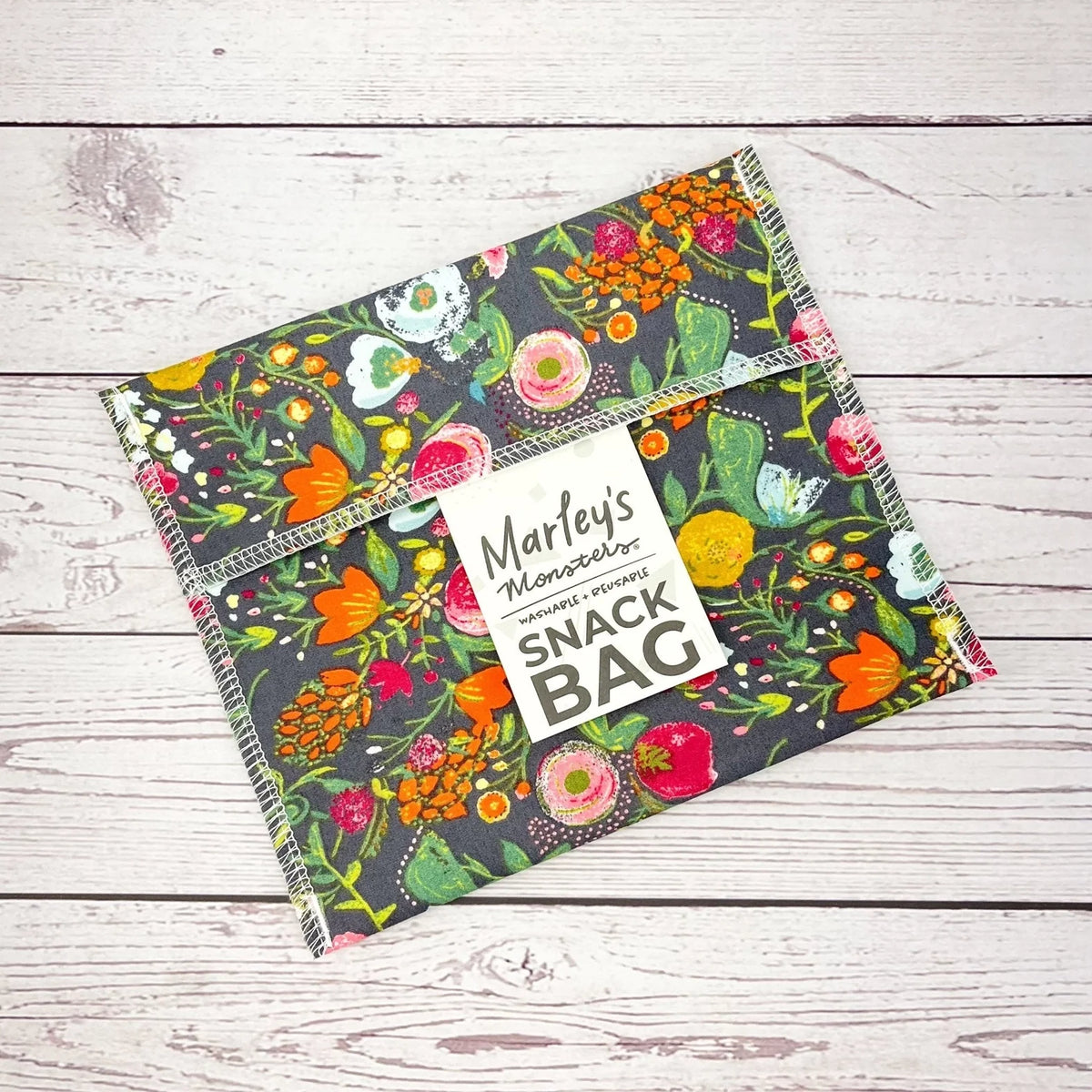 Reusable snack bag with bright floral garden print and decorative stitched border
