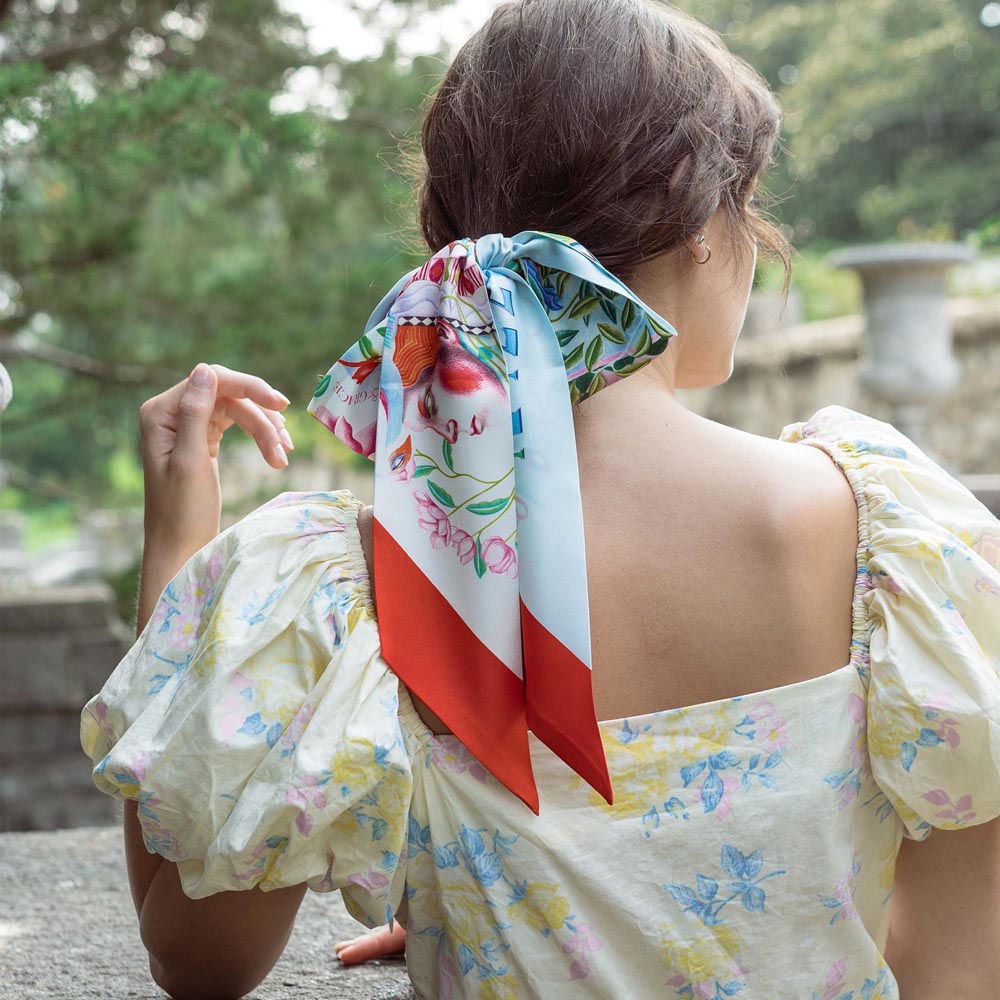 Silk twilly scarf in light blue and red, floral animal print, tied bow