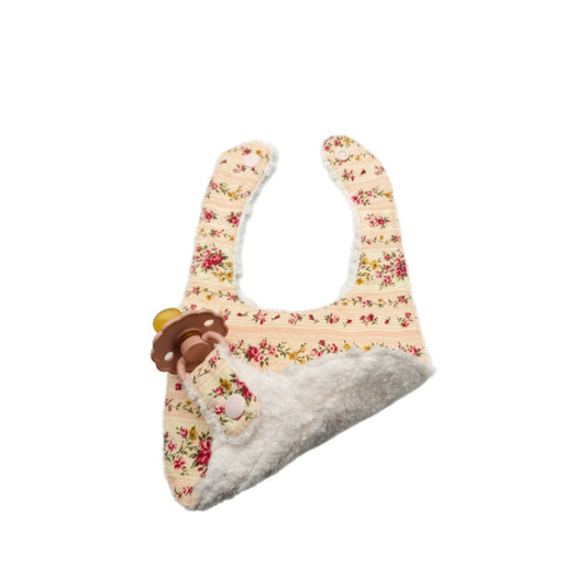 Floral pacifier bib with soft white terry backing and teether clip at the corner.