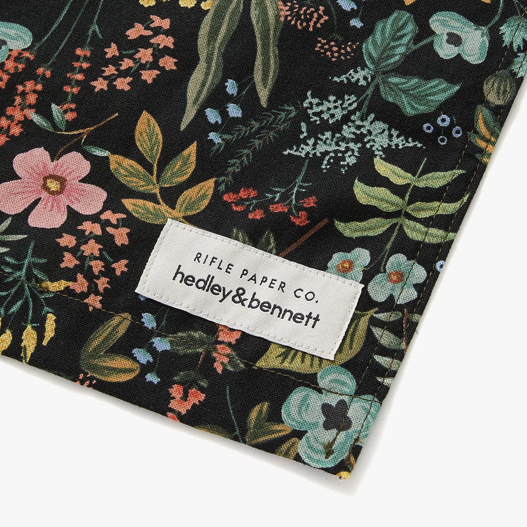 Black floral apron hem with woven brand label
