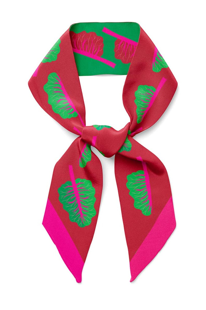 Twilly ribbon scarf with green and magenta leaf print, neatly tied at the neck