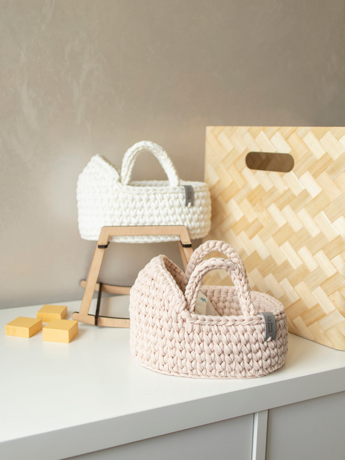 Woven mini moses basket with rocking stand on a display shelf