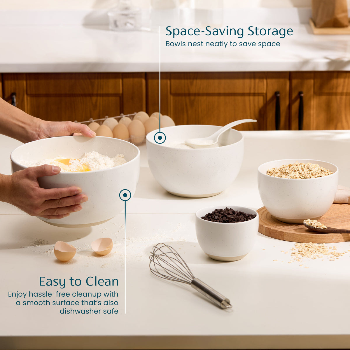 Ceramic nesting bowls set with speckled off-white finish, assorted bowls on a countertop